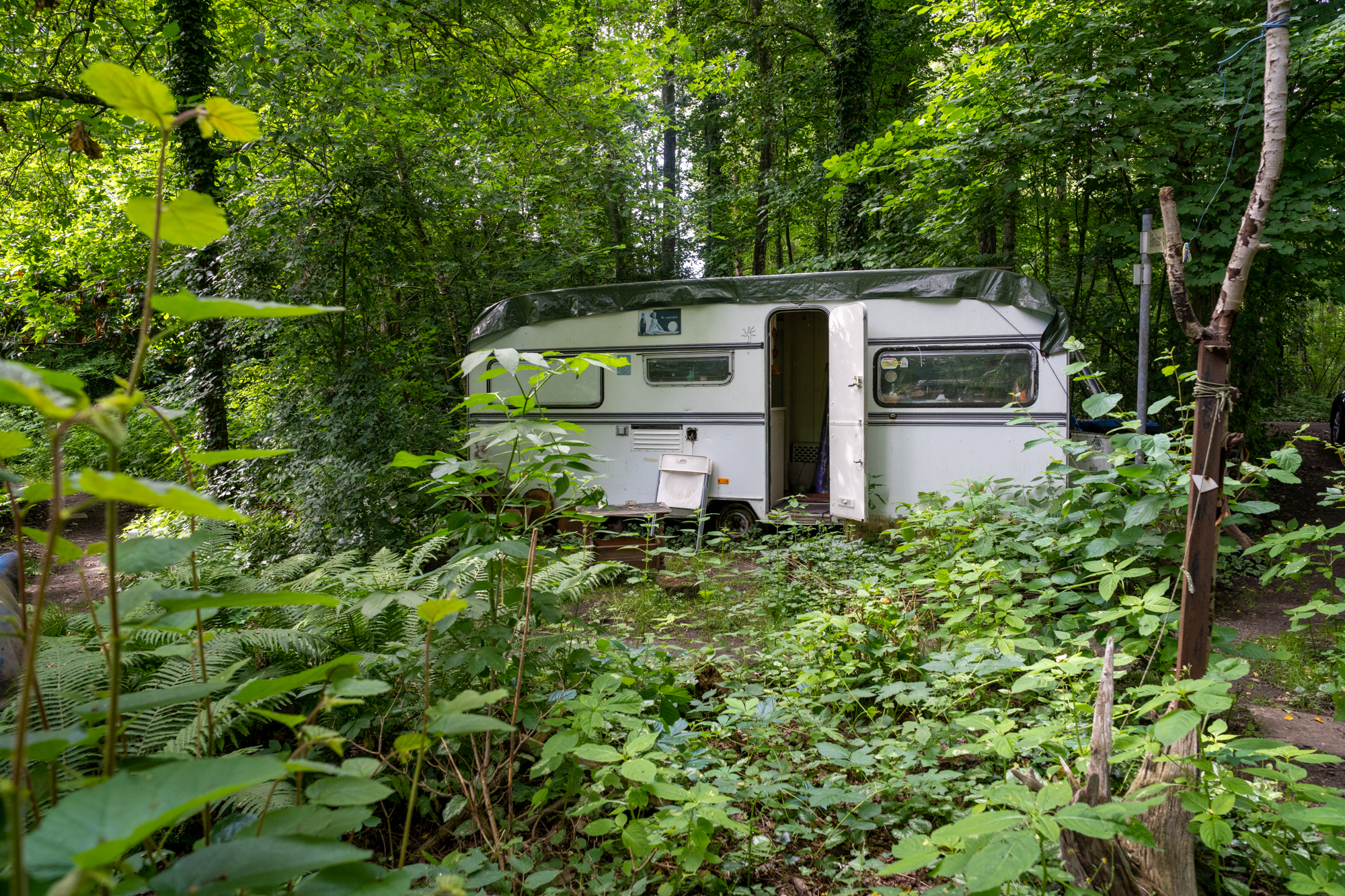 #f9d4c7 #offcolor A discarded caravan serves as her studio, housing their workshop with two workstations.